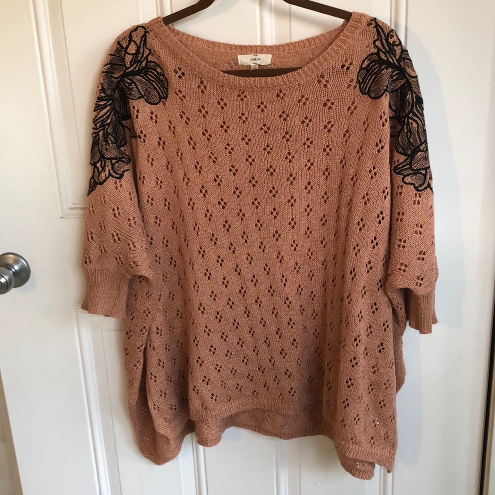 Coral sweater, black floral stitching on shoulders